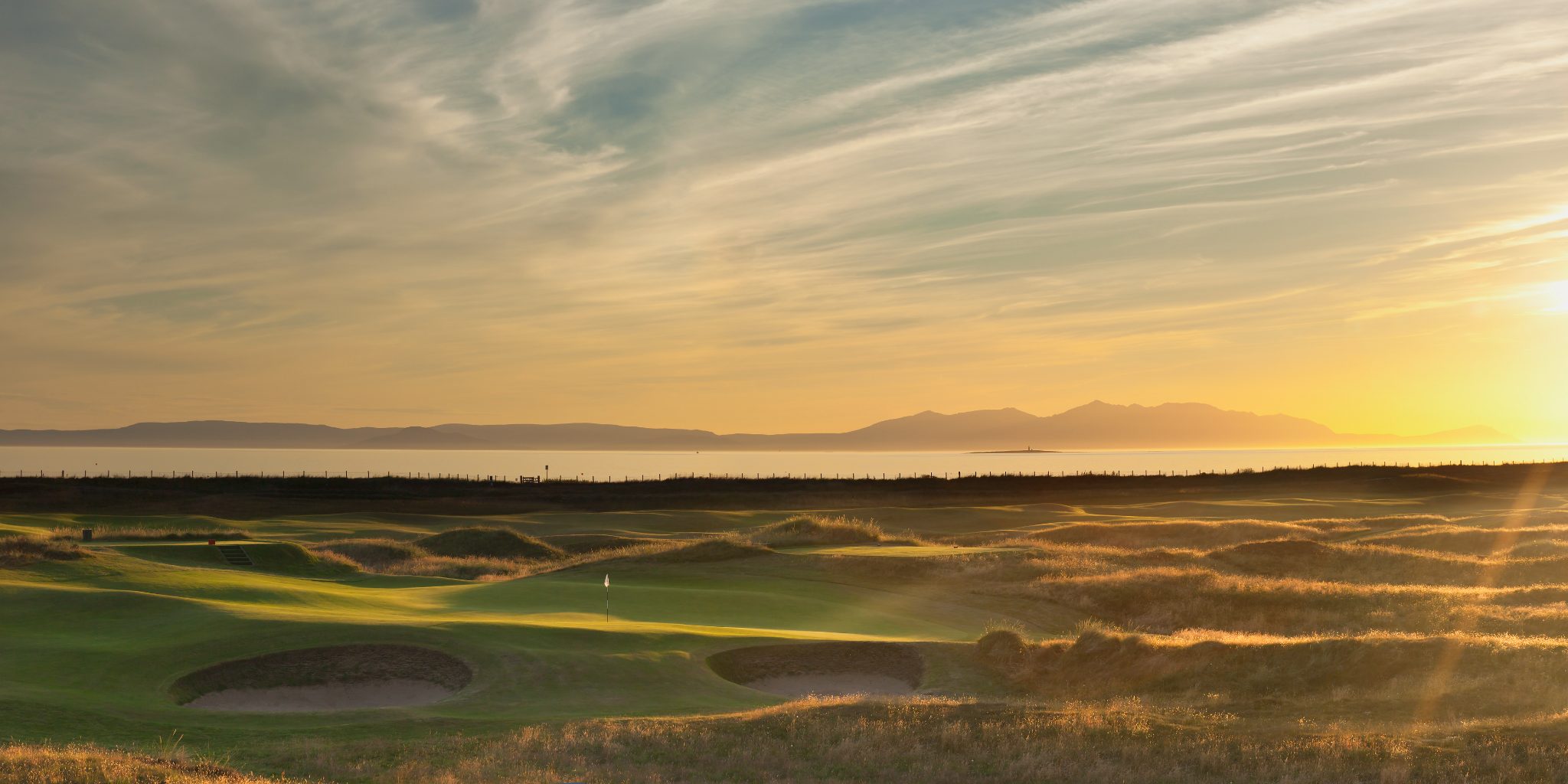 Ayrshire Golf Course with Arran in sunset silhouette